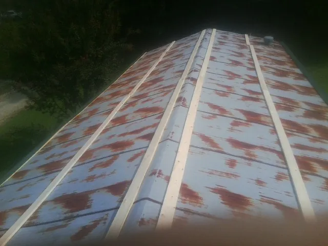 Rusted metal roof panels with new wood purlins before replacement — Storm Damage Roof Repair in Tampico by Roofing Brothers
